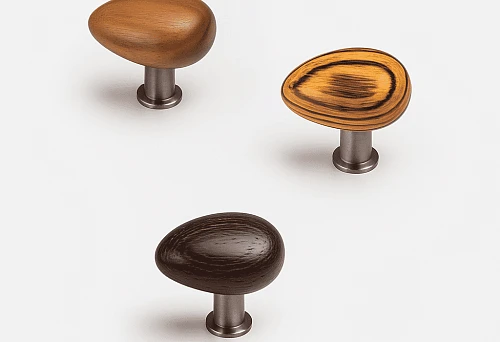 Three stylish wooden furniture handles in different shades on metal bases