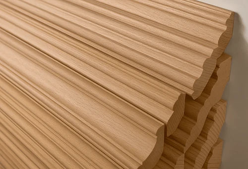 Wooden planks of various profiles arranged on a stand, showcasing the texture and shape of natural wood.