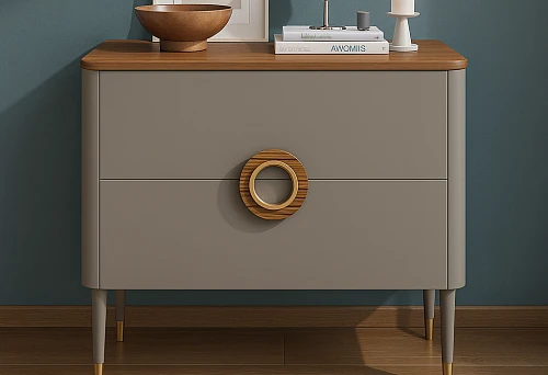 A stylish chest on high legs with gold accents.