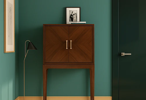 A stylish wooden cabinet on high legs with gold handles in an elegant interior.