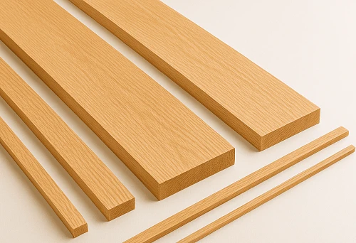 Wooden planks of various sizes and thicknesses on a light background.