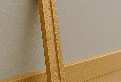 Vertical wooden baseboard against wall and floor