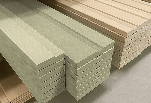Smooth straight wooden skirting in green and beige colors &mdash; side view