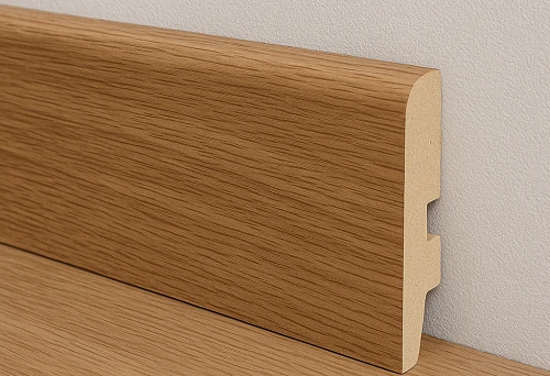 Baseboard MDF with oak finish, installed along a light-colored wall and floor.