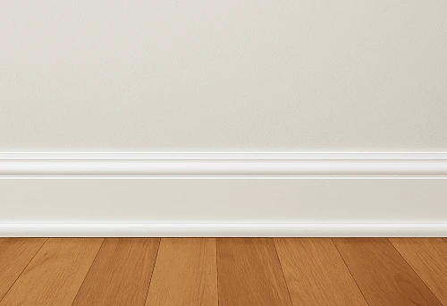 White baseboard at the junction of wall and wooden floor &ndash; classic interior design option