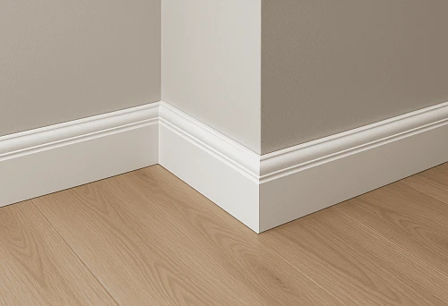 White baseboard at the junction of light floor and wall in a modern interior