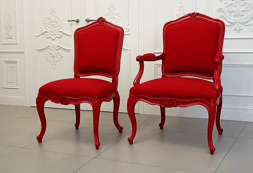 Classic chairs with red upholstery and carved wooden frame.