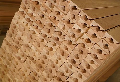 Stack of wooden decorative profiles with carved elements