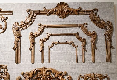 A set of carved wooden elements of various sizes, neatly arranged on a display stand.