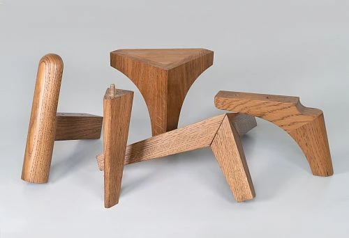 Various forms of wooden supports and angles, made from solid oak, demonstrating the versatility of design and finishing of natural materials.