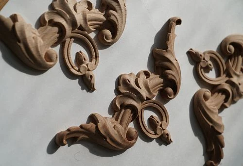Three Decorative Carved Wooden Elements on the Surface, Reflecting Fine Detailing and Woodworking Craftsmanship