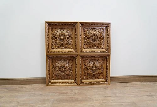 Four decorative wooden panels with carved ornamentation in the form of leaves and floral motifs