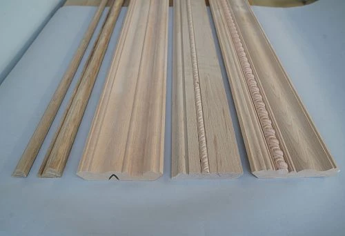 Decorative wooden moldings and cornices for ceiling, made from natural solid wood.