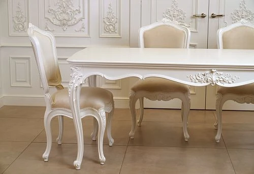 White carved solid wood chairs with soft upholstery