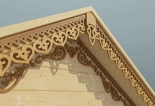 Wooden carved pediment with decorative ornamentation