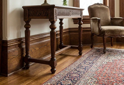High-profile wooden baseboards along the wall in a classic interior next to a carved table and armchair