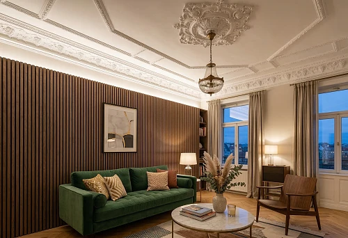Slat wall panels in a living room interior with a green sofa and ceiling moldings
