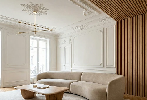 bright living room with stucco decor and wooden slat wall