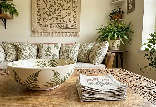 Botanical ornament in interior design: decorative patterns on textiles and carved wooden tabletop