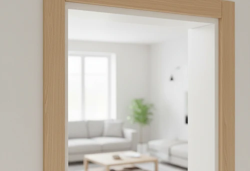 Modern wooden architrave in a light shade, installed around a door opening in a living room interior