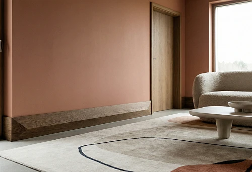 High wooden baseboard in a modern interior: wide plank by the wall, clean geometry and warm wood texture