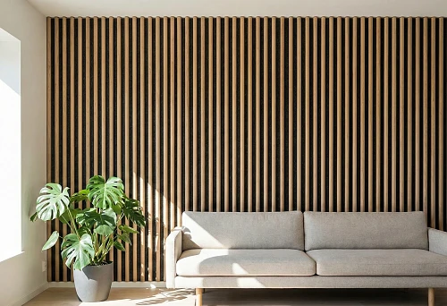 Slatted wall panel made of wooden slats, vertical lamellas on a dark backing in a modern interior