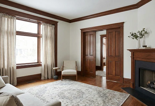 Modern Living Room with Wooden Window and Door Trims: Wide Casings, Brown Fireplace Portal