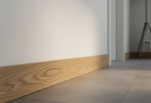 Solid Oak Wooden Skirting Board Along a Light Wall, Emphasizing the Joint Between Tile Floor and Wall