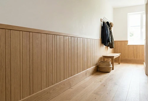 Corridor with a bottom row of wooden panels and a high skirting board, protecting walls and creating a neat interior