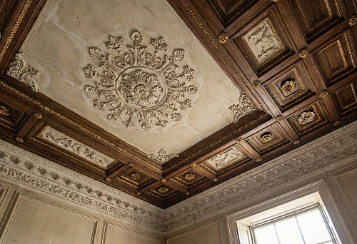 Decorative ceiling decoration: coffers, stucco, and gilded accents in a classic interior