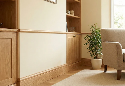 Wooden skirting board along the wall and round decorative molding as a border, neat joints and warm wood texture