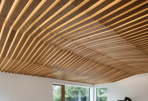 Decorative oak rails on the ceiling of a modern interior with soft lighting
