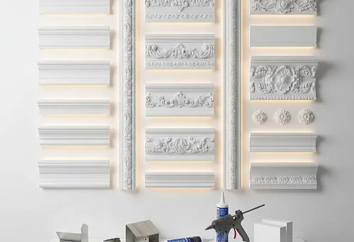 Collection of decorative polystyrene cornices of various profiles and styles on a stand with installation tools