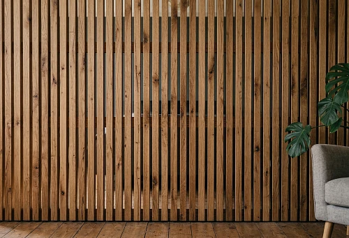Wooden wall slat panel in an interior with natural wood texture and vertical rhythm