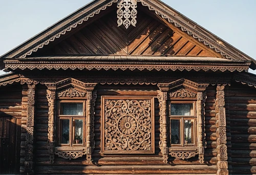 Facade of a wooden house with carved window trims and ornamentation