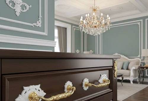 Furniture handles with decorative molding on dark facades, matching the molded decor of walls and ceilings in a classic interior with a chandelier