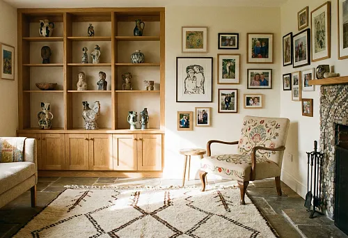 living area with wooden shelving and a ceramic collection