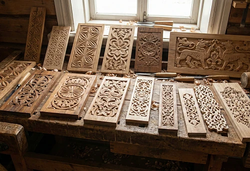 Wooden Patterns and Types of Carving: Carved Panels with Geometric and Floral Ornaments on a Master's Workbench