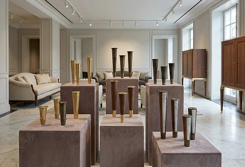 Premium furniture legs and furniture supports on podiums in the showroom: brass and dark metal for sofas and cabinets