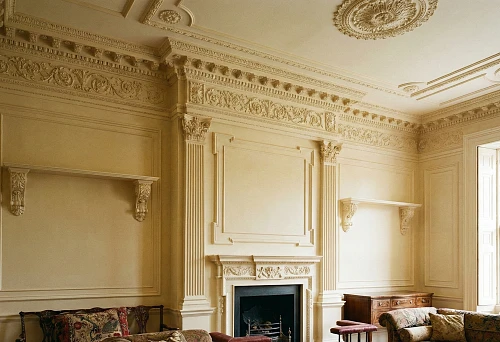 Polyurethane stucco on the wall: classic moldings, panels, and cornices create architectural relief in a light interior