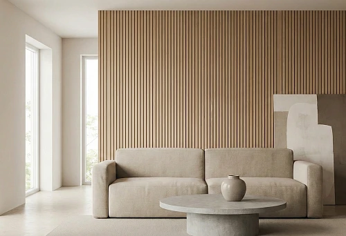 Thin wooden slats on the wall in a minimalist living room with a beige sofa and a round table
