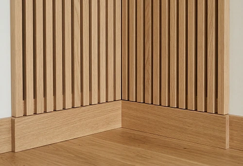 Installation of slatted panels and wooden baseboard with precise corner joint without gaps or unevenness