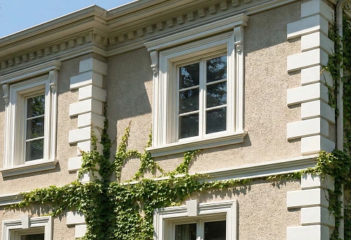 Polyurethane facade stucco molding on a house: cornices, architraves, and rustications as wall protection and decoration