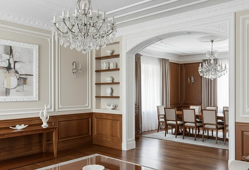 Interior with wooden panels and polyurethane molding, arch and crystal chandeliers