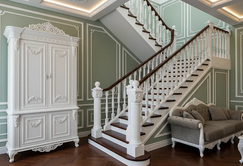 Interior with molding and carved stair newels, where decor emphasizes furniture and room architecture