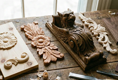 Solid wood decorative elements: carved overlays with floral ornament on a workbench