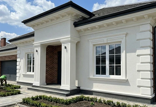 Polyurethane facade stucco on a house: cornices under the roof and window trims