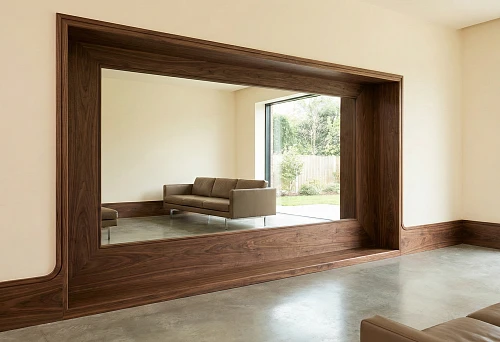 A wooden high baseboard and mirror panel frame in one line create the effect of built-in decor in a modern interior