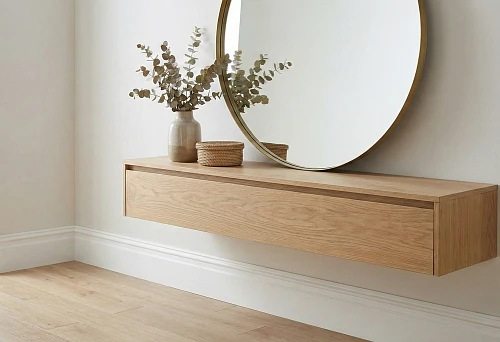 Bright hallway with white floor baseboard about 80 mm; on the wall a large round mirror approximately 120 cm in a thin metal frame