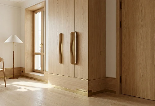 A bright interior with wooden doors, cabinets, and smooth furniture handles in a unified style